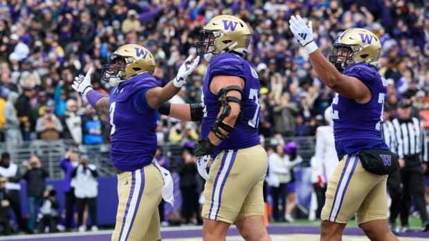 Dillon Johnson, Roger Rosengarten and Parker Brailsford celebrate a UW touchdown.